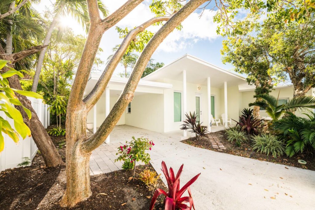 Beach house entrance exterior with added paver walkway. Luxury Beach House