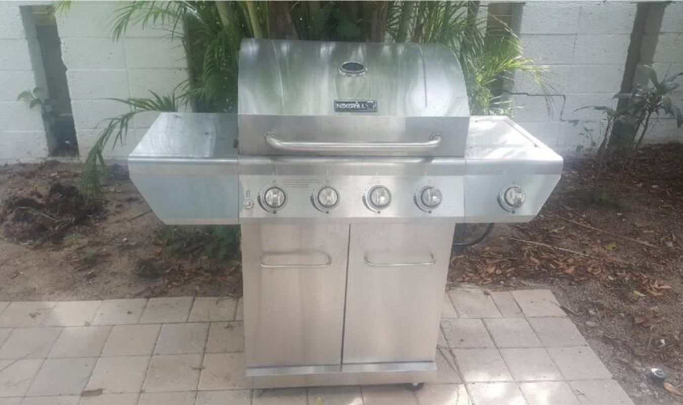 Gas grill with tools for back yard.